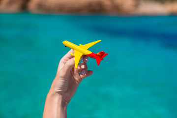 Small homemade plane in hand on background of the sea