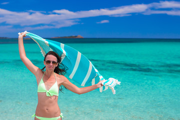 Happy woman have fun with beach towel and very happy