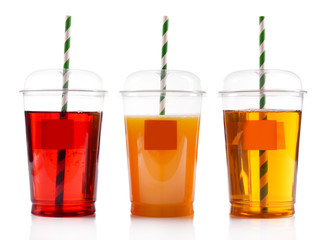 Fruit juices in fast food closed cups with tubes isolated