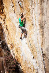 Fototapeta premium Young male rock climber on cliff