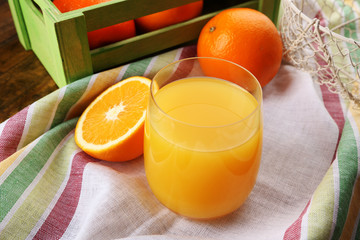 Glass of orange juice with crate