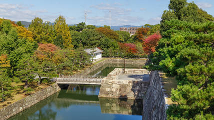 Fototapeta na wymiar A Moat with Crossing Bridge at a Nijo Castlein Kyoto