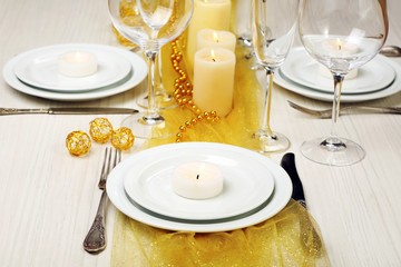 Beautiful holiday table setting in white and gold color