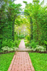 Lush green garden with wrought iron arbor