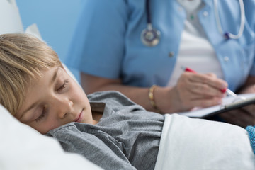 Kid sleeping in hospital bed