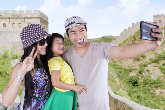 Attractive family taking pictures in the Great Wall