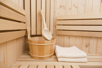 Fototapeta na wymiar Detail of bucket and white towels in a sauna