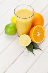 Citrus fruits and glass of juice. Oranges, limes and lemons