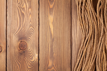 Wooden background with marine rope