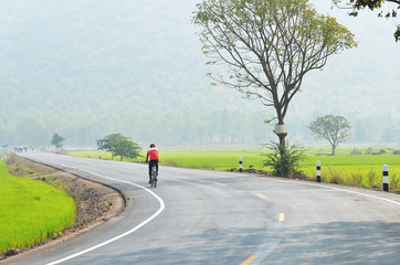 Man bike on road in countryside of Thailand  