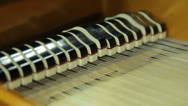 Work  hammers inside the grand piano with the lid open, close-up