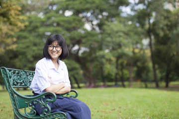 Girl smile and sitting on the bench.