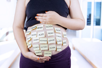 Pregnant belly with baby names