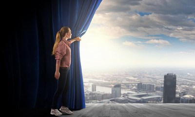 Girl opening curtain