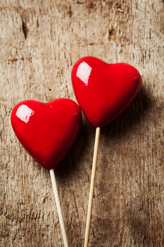 Valentine day concept:  two red hearts on wooden background