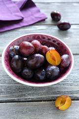 Fresh plums in a small bowl