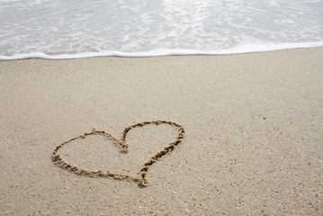 heart line on on the beach with sea wave