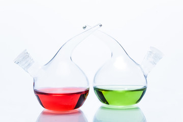 Two transparent glass dropper bottles with color liquid