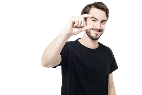 Man showing small amount with fingers