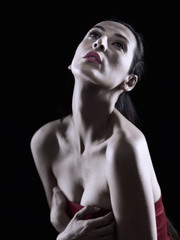 Portrait of a beautiful woman posing with a neckline red dress