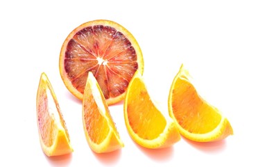 Slices of red oranges isolated on white background