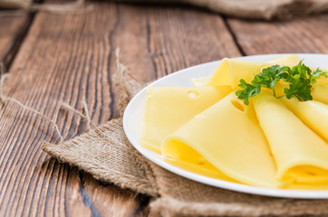 Sliced Cheese on wooden background