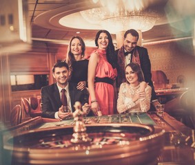 Group of stylish people playing in a casino