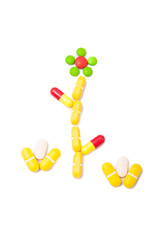 Flower made from pills on white background