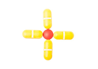 Cross or plus sign made with pills