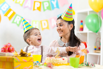 Fototapeta premium child and his mom have fun on birthday