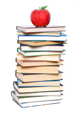 Books tower with apple isolated on white