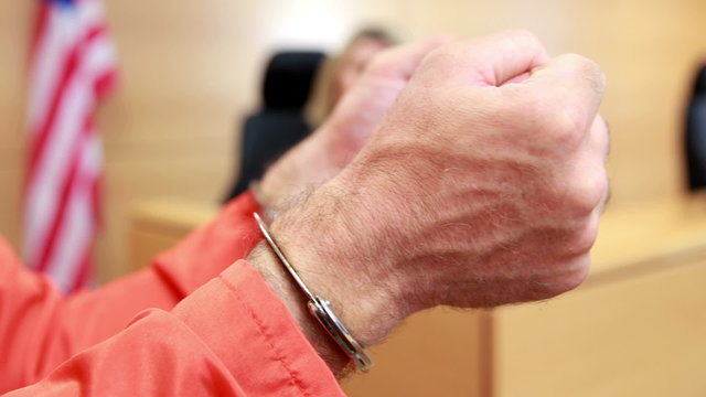 Close up of a criminal hands with handcuffs