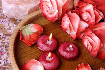 Spa concept with roses, pink salt and candles that float in wate