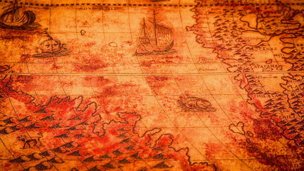 Vintage magnifying glass lying on ancient world map in 1565.