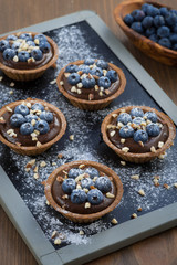 chocolate mousse with fresh blueberries and nuts in tartlets
