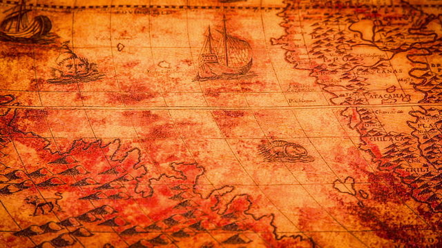 Vintage magnifying glass lying on ancient world map in 1565.
