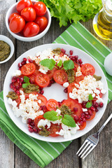 salad with tomatoes, cottage cheese, mint pesto, pomegranate