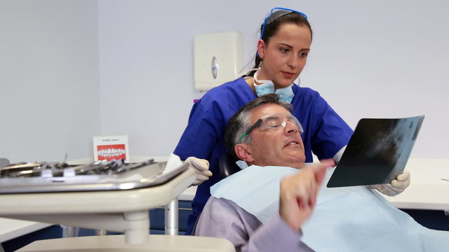 Dentist showing patient his xrays