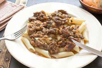 Beef goulash with macaroni in plate