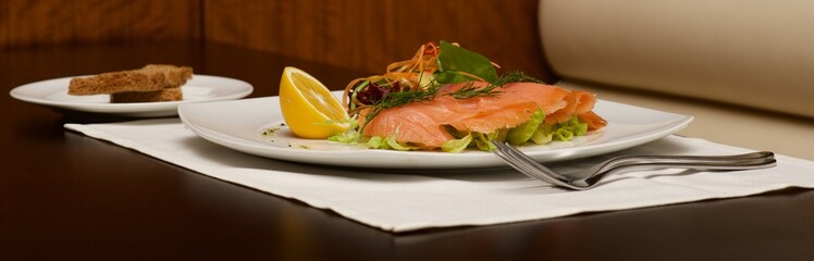 Panorama of smoked salmon platter and toast