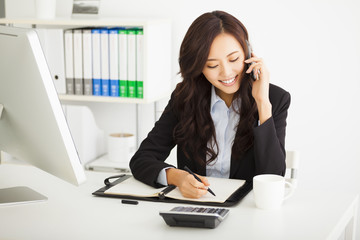 happy young businesswoman working in the office