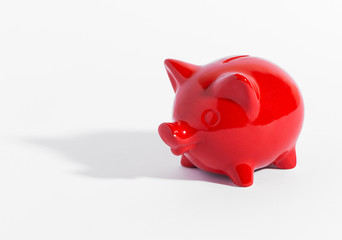 Red ceramic piggy bank or money box on white