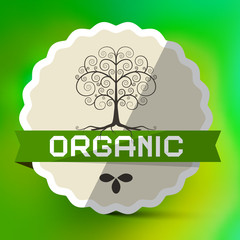Organic Label with Tree Sign on Green Blurred Bokeh Background