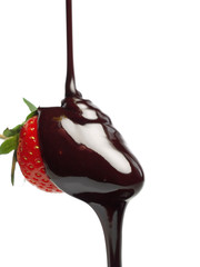 Pouring chocolate sauce on strawberry