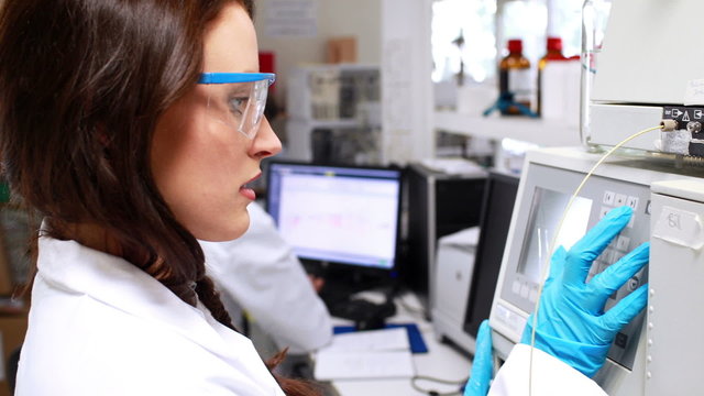 Chemists working in a laboratory on computer