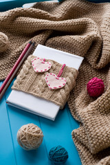 One old notebook in knitted cover with felt hearts