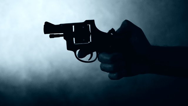 silhouette of a mans hand with a handgun,real time