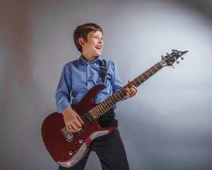 teenager boy 10 years of European appearance smiles plays gui