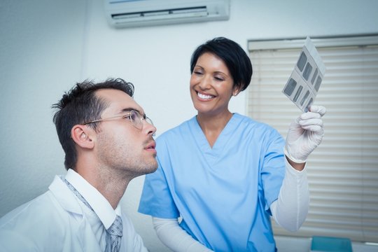 Dentists looking at x-ray