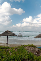 Red flag on the stormy sea resort beach